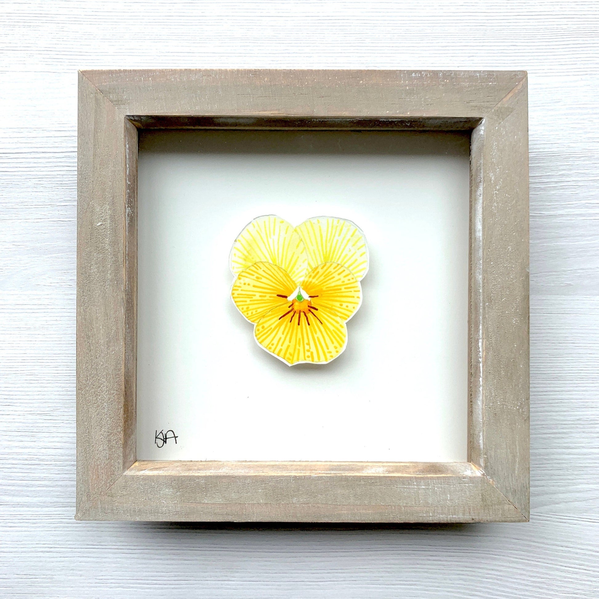 A hand-painted vibrant yellow pansy flower watercolour in a rustic washed effect box frame.